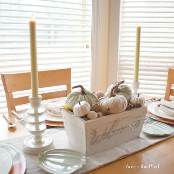 casual fall centerpiece with candles pumpkins
